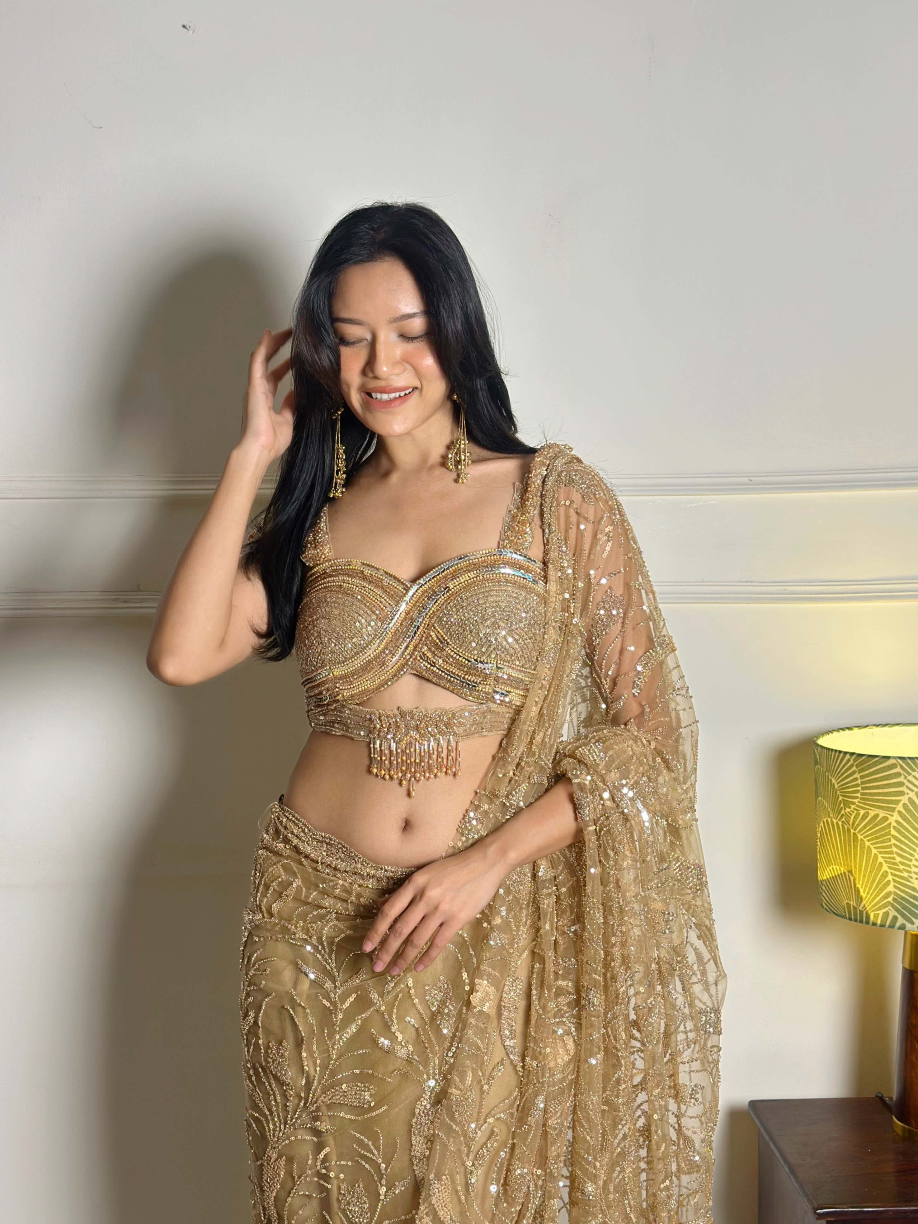 Jelina Derapi in a gold sequinned festive lehenga with a matching dupatta